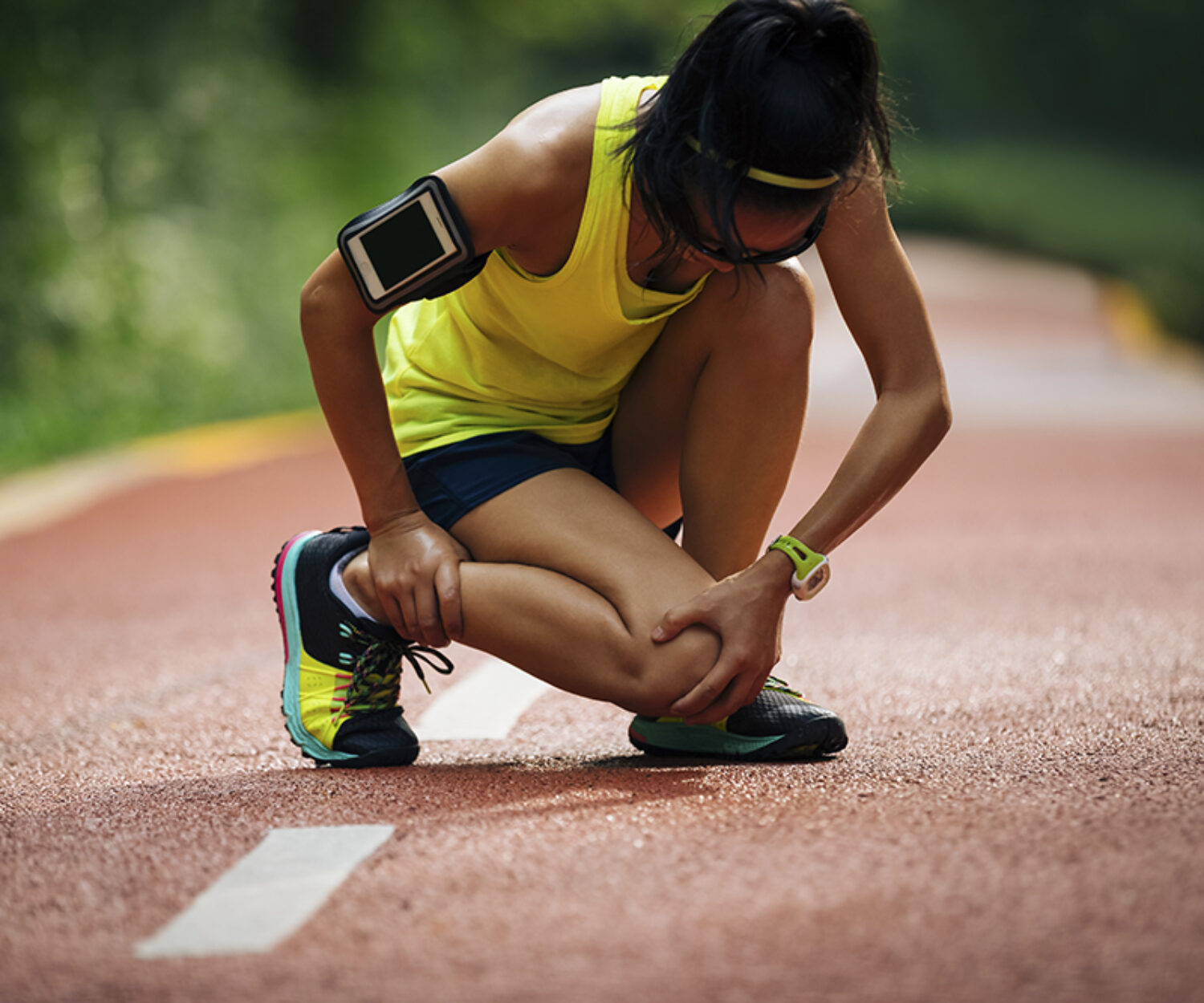 Female runner suffering with pain on sports running knee injury