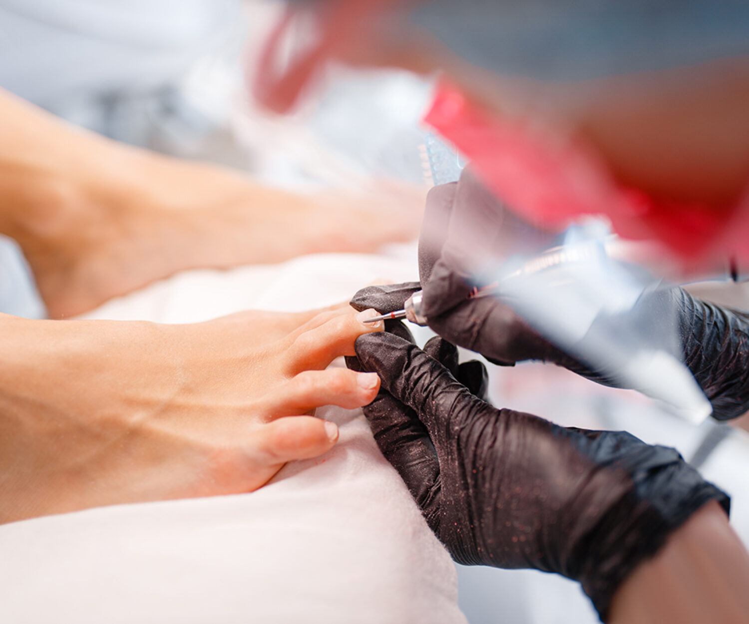 Cosmetologist salon, pedicure, polish procedure. Nail care treatment for female client in beauty shop, doctor in gloves works with customer toenails